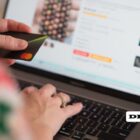 This picture includes a person entering credit card information into a website while shopping online.