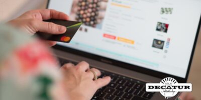 This picture includes a person entering credit card information into a website while shopping online.