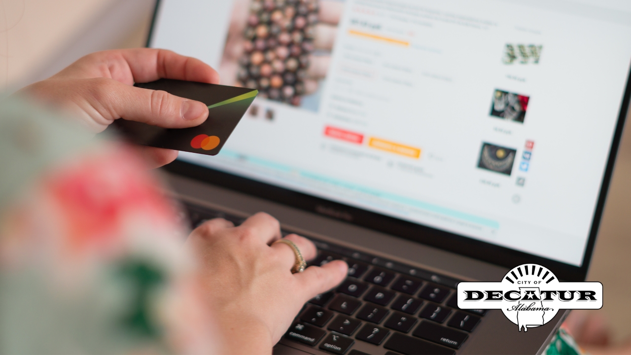 This picture includes a person entering credit card information into a website while shopping online.