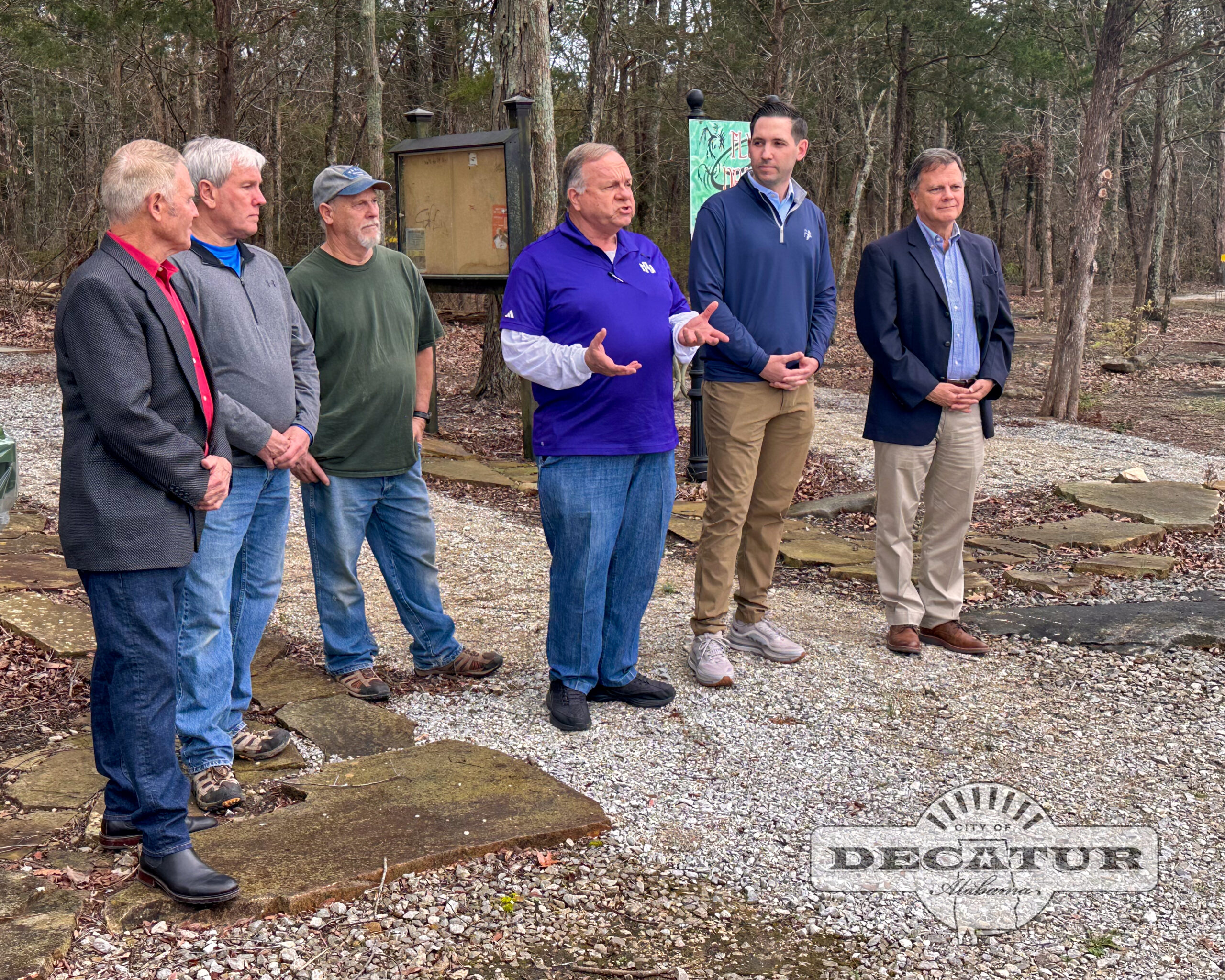 Volunteers, city leaders, and Senator Arthur Orr gather at the Flying Dragon Disc Golf Course to celebrate it's renovations.