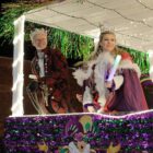 The picture shows participants in the evening Mardi gras parade in downtown Decatur