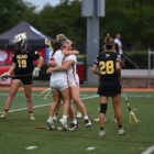 NAIA Lacrosse players celebrate in this picture after scoring a goal.