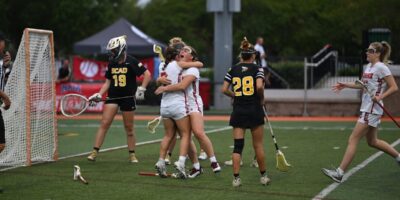 NAIA Lacrosse players celebrate in this picture after scoring a goal.