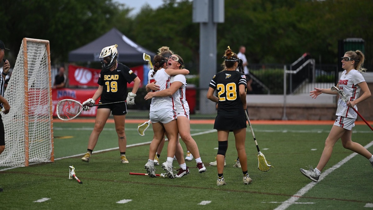 NAIA Lacrosse players celebrate in this picture after scoring a goal.